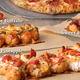 Illustration for article titled Dominos is making pizza with breaded chicken as the crust